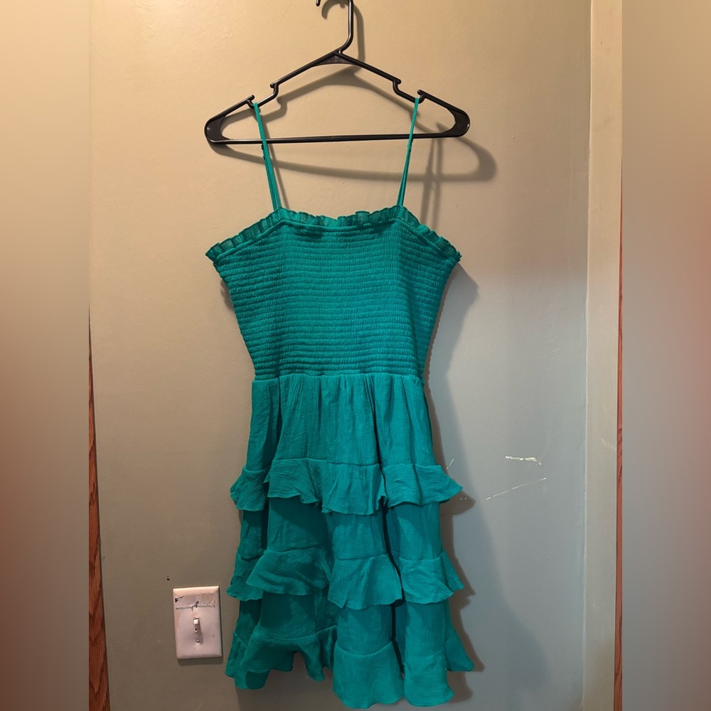 woman’s green ruffle dress